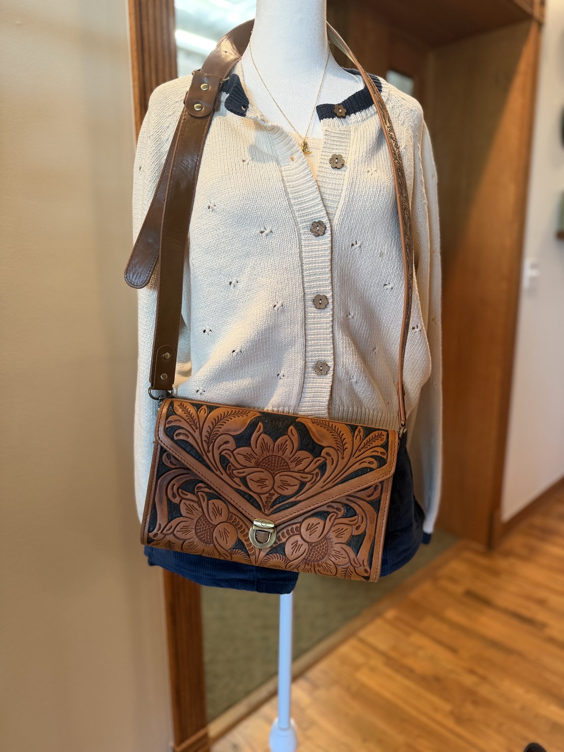 Hand-tooled leather floral crossbody bag styled on model
