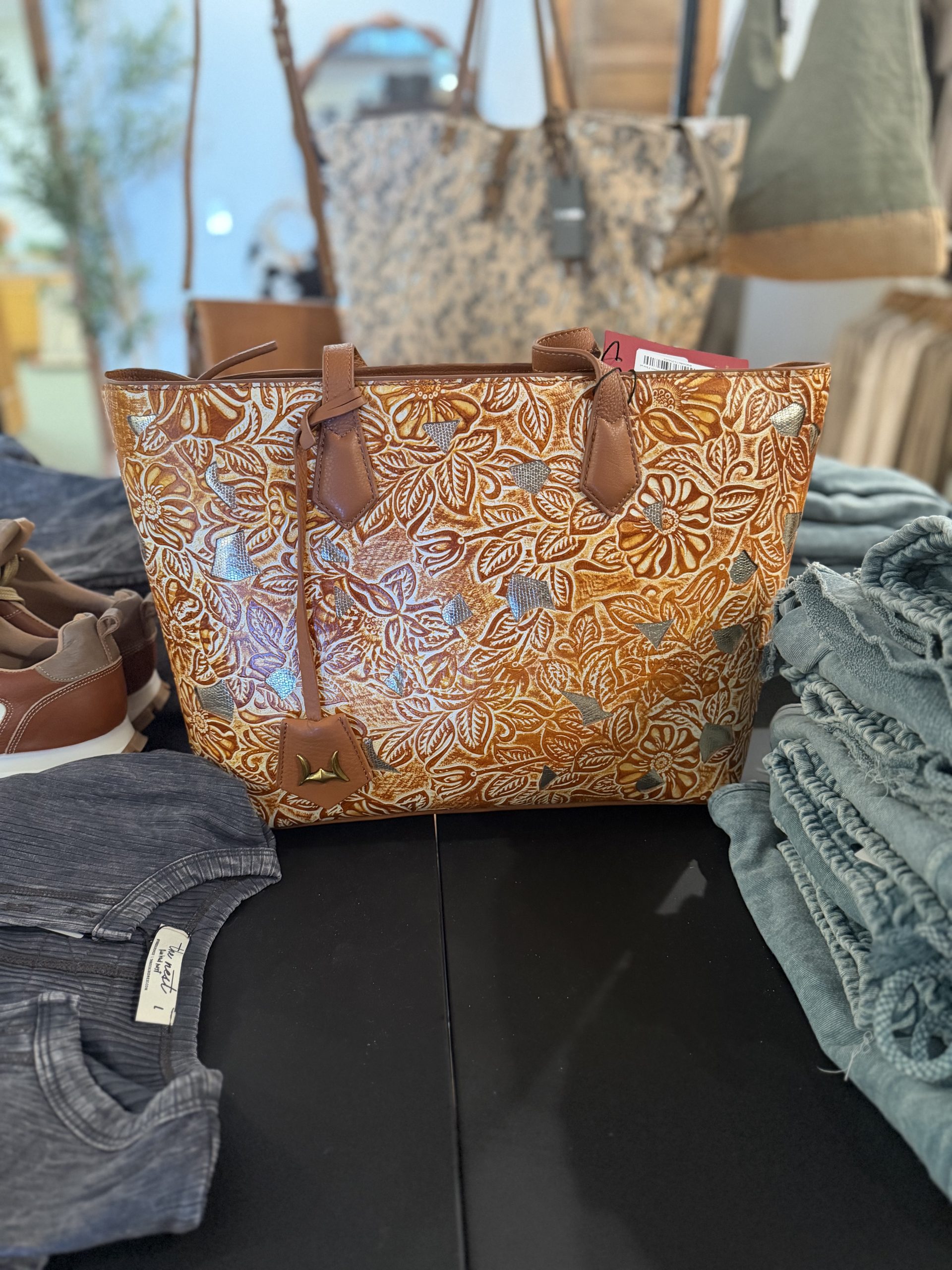 Hand-tooled leather tote with metallic floral accents
