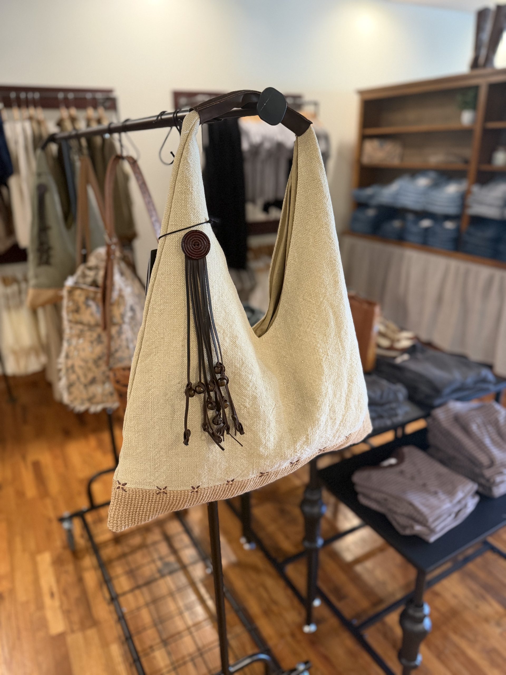 Woven canvas hobo bag with leather tassel detail
